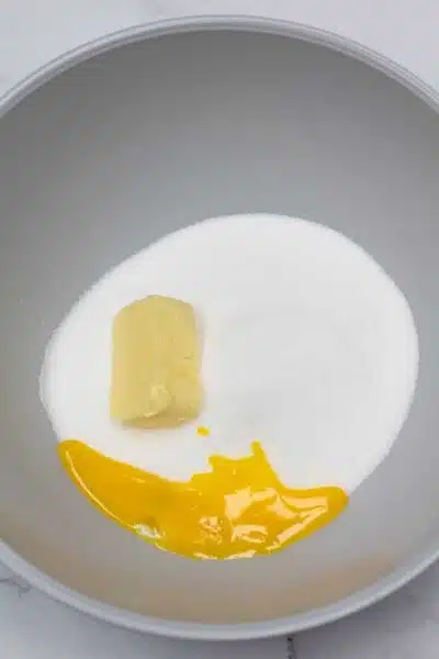 Process photo 2 cream together sugar, shortening, and egg yolk.