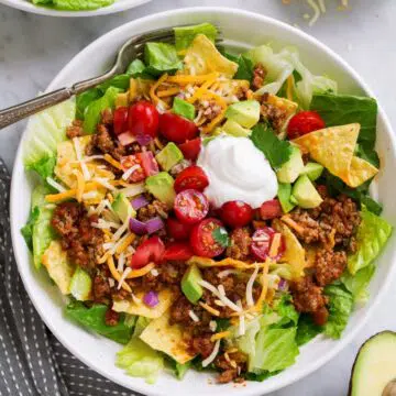 Taco salad served in white bowl.