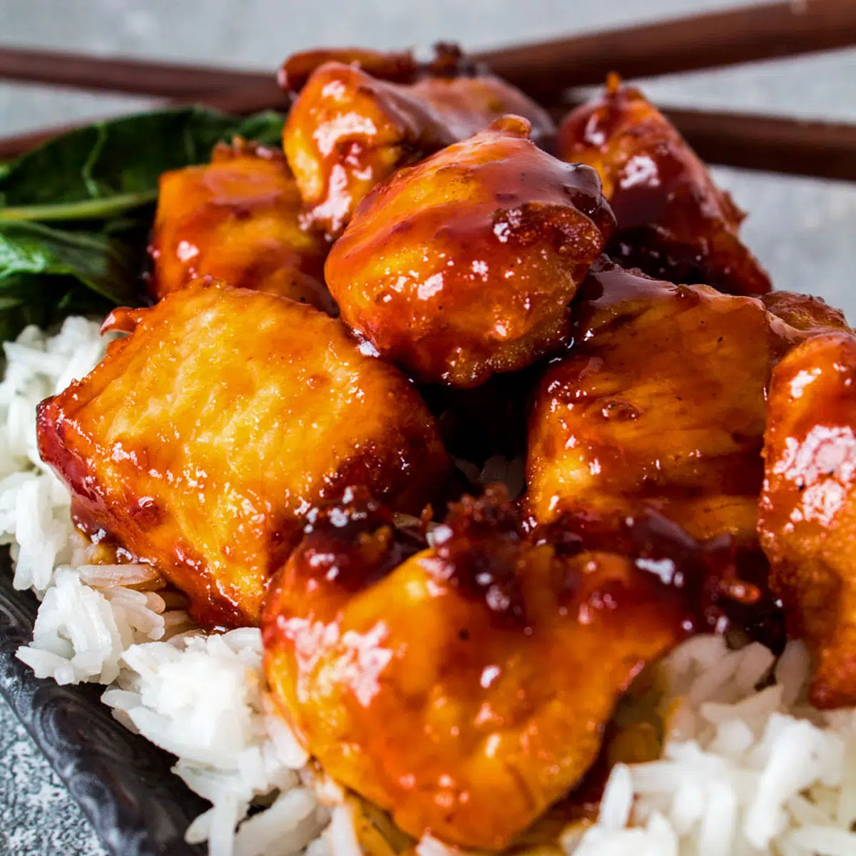 General Tso's chicken served over steamed rice with bok choy.