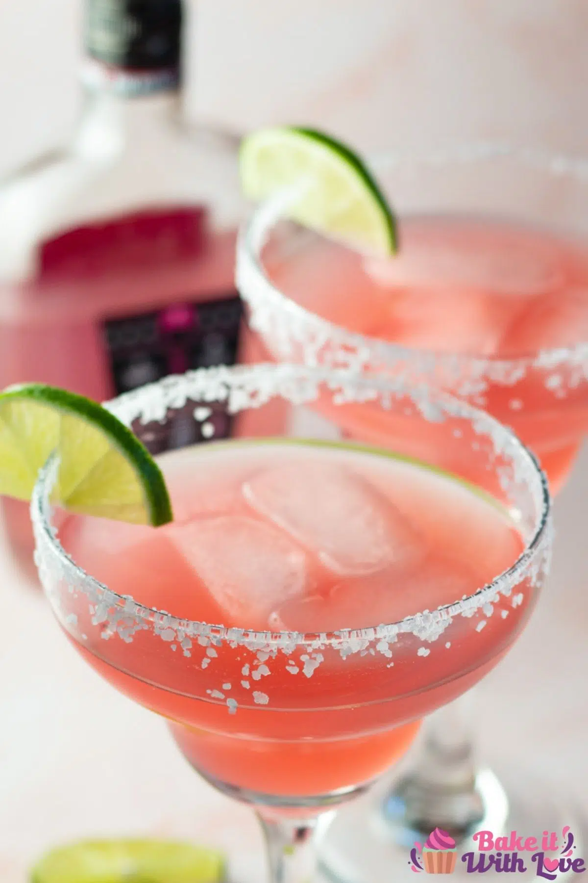Pink vodka margaritas with Pink Whitney bottle in background.