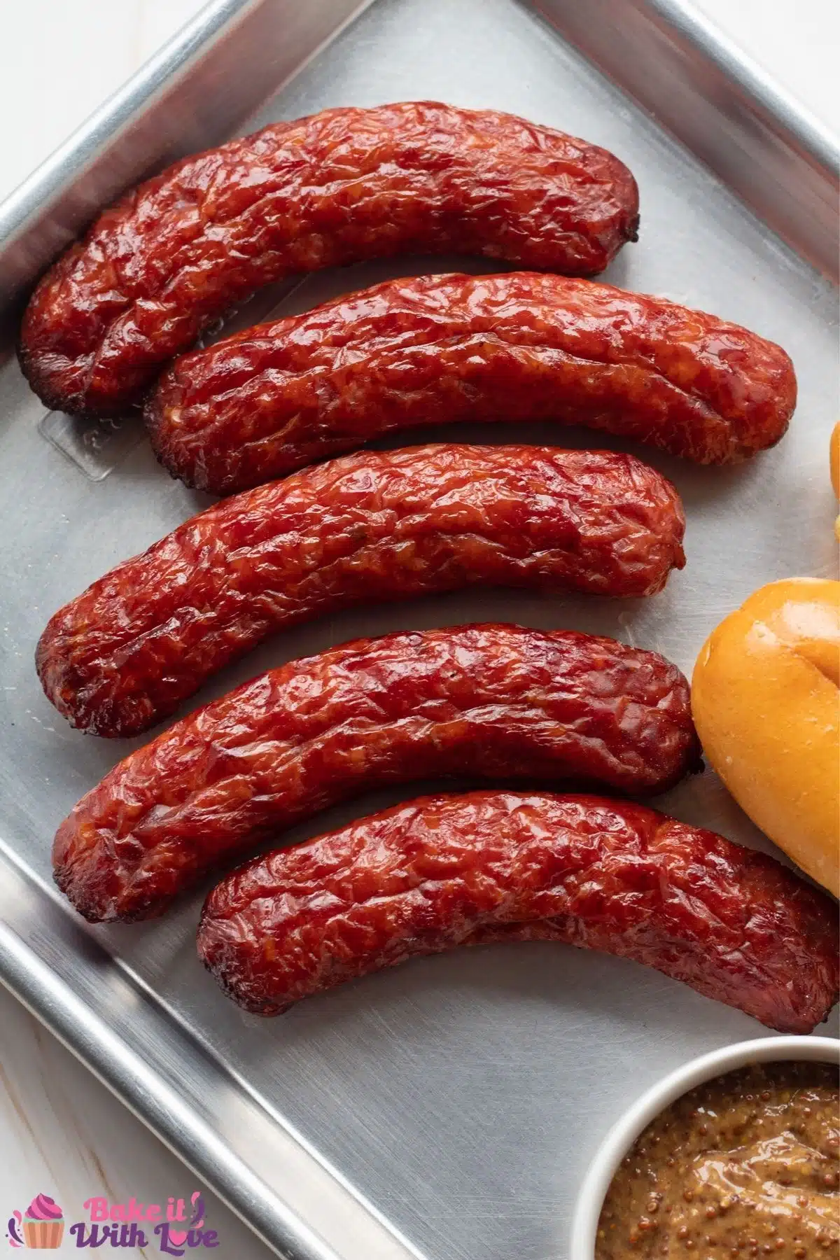 Tall overhead image of the smoked italian sausage on metal tray.
