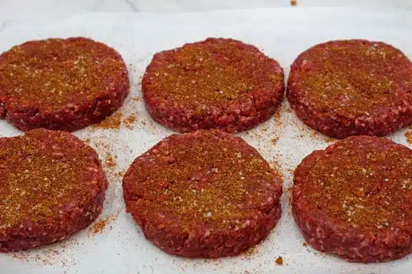 Process photo 3 of the seasoned hamburger patties.
