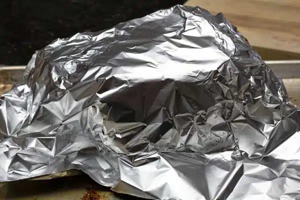 Process photo 6 of resting the smoked roast loosely tented with aluminum foil.