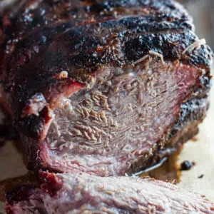 Tender, pull apart smoked pork butt roast sliced open to show the smoke ring.