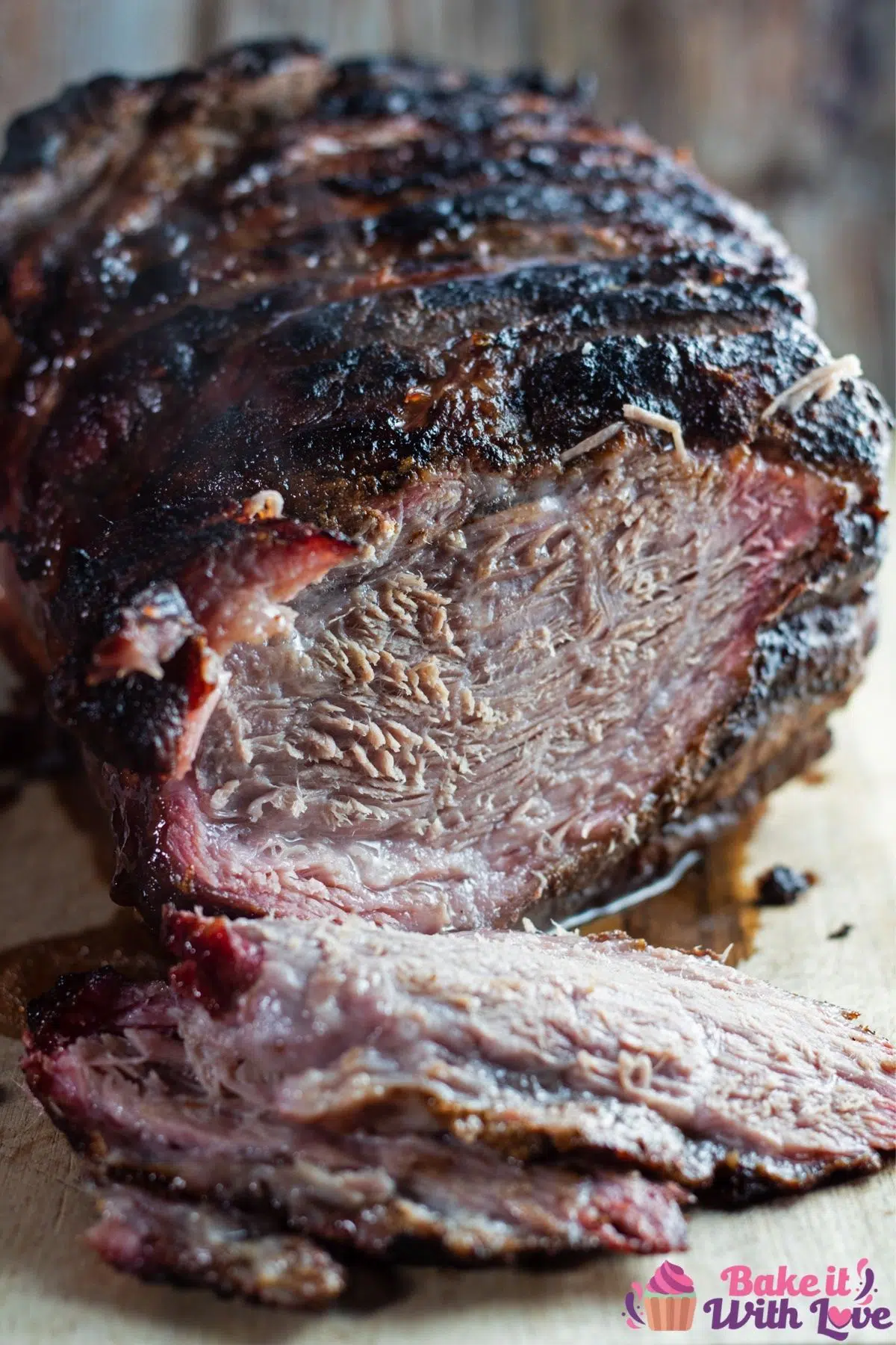 Tallcloseup of the sliced smoked pork roast on cutting board.