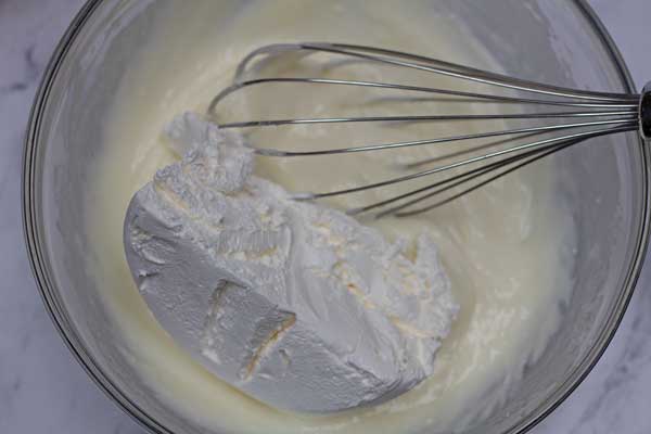 Process photo 4 of adding Cool Whip to the cream cheese mixture.