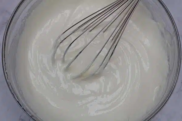 Process photo 5 mixing all of the cream cheese layer ingredients until smooth.