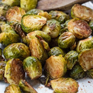 Wide image of the balsamic roasted brussel sprouts on baking sheet.