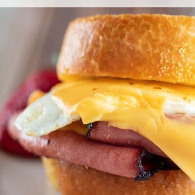 Pin image of a fried bologna and egg sandwich close up.