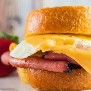 Close up image of a fried bologna and egg sandwich.