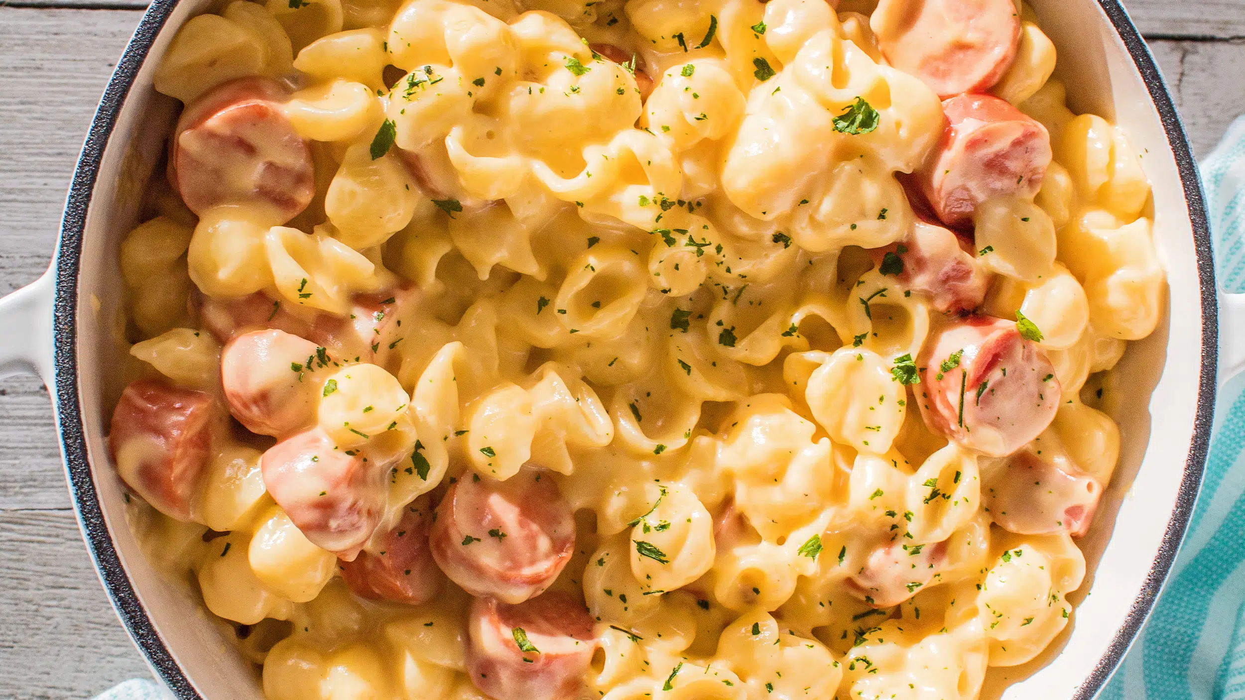 Wide iverhead image of the mac and cheese with hot dogs.