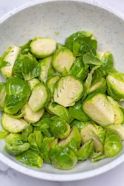 Process photo 1 sliced brussel sprouts tossed with oil and seasoning.