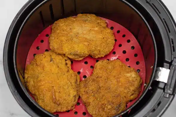 Process photo 2 of flipping the air fryer country fried steaks.