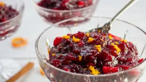 Wide side image of the apple cider cranberry sauce in crystal serving dish.