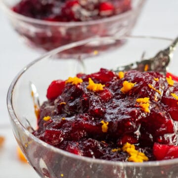 Wide side image of the apple cider cranberry sauce in crystal serving dish.