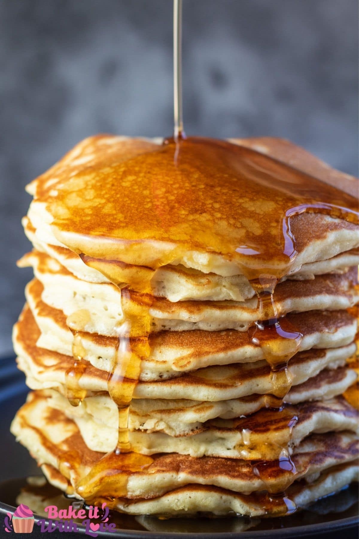 Stacked Bisquick pancakes with syrup drizzling down the sides.