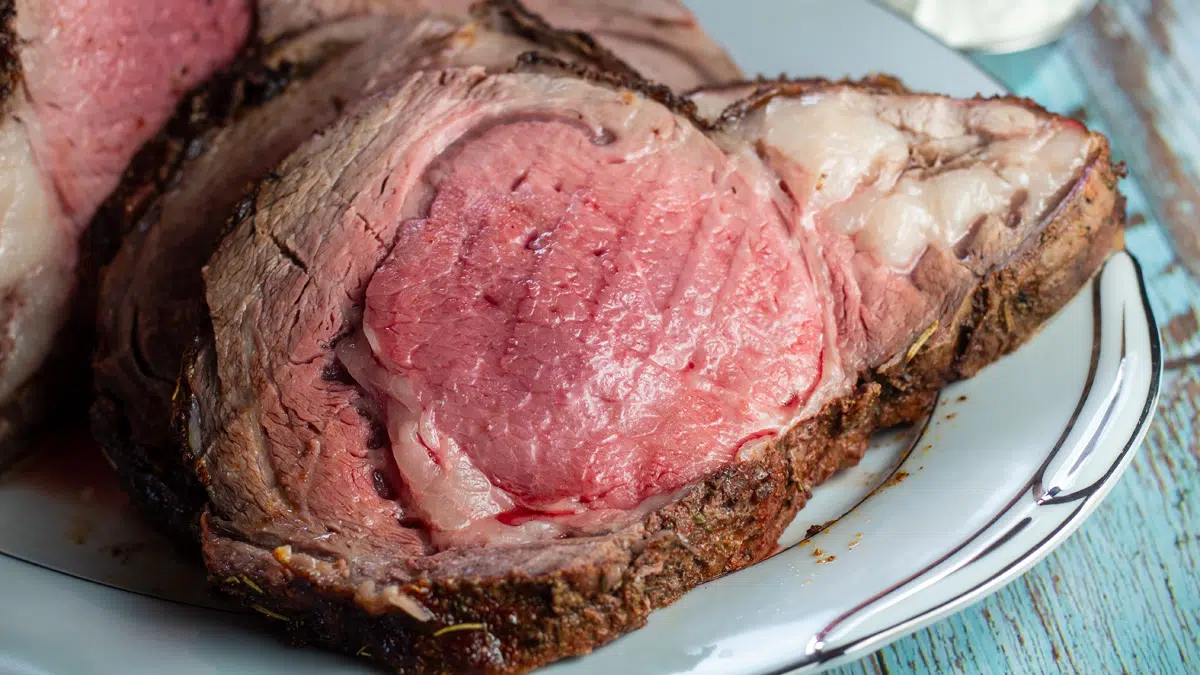 Wide closeup image of sliced boneless prime rib roast.