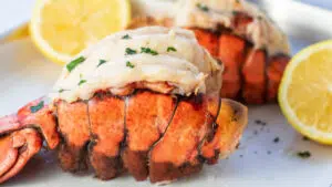Wide image from the side of the broiled lobster tail.