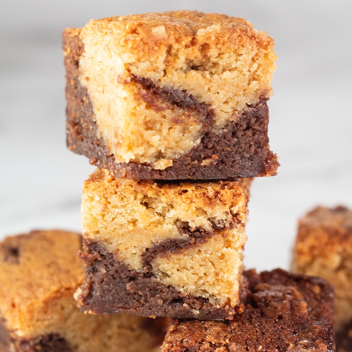 Brownie blondies stacked to show the tasty layers and marbling.
