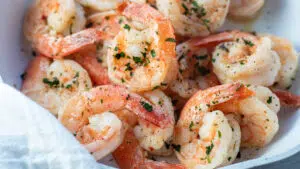 Wide image of the garlic butter shrimp garnished with parsley.
