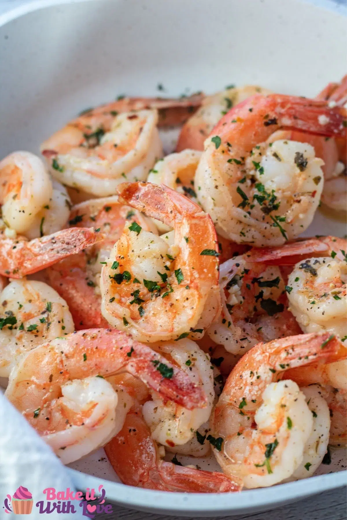 Tall image of the garlic butter shrimp in skillet.