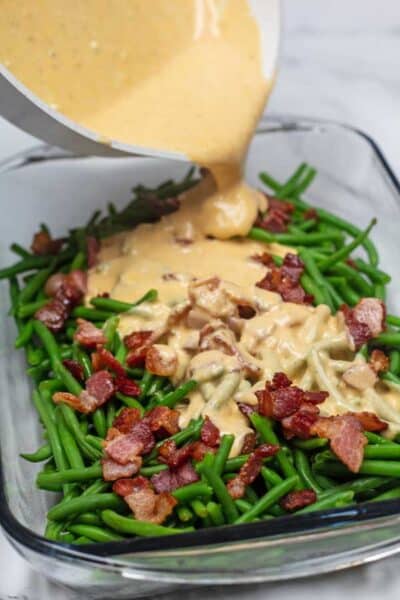 Process photo 6 pour the cheese sauce over green beans and bacon.
