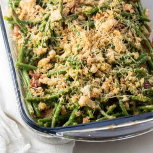 Closeup square image of the baked green bean casserole with bacon.