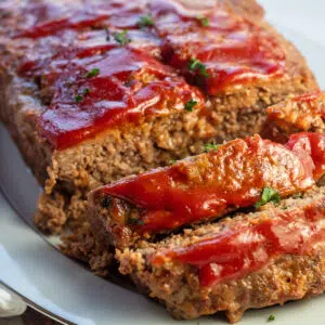 Lipton onion soup meatloaf sliced and ready to serve on platter.