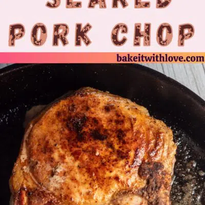 Pin image of seared pork chops in a pan.