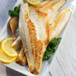 Perfectly pan seared sea bass on platter.