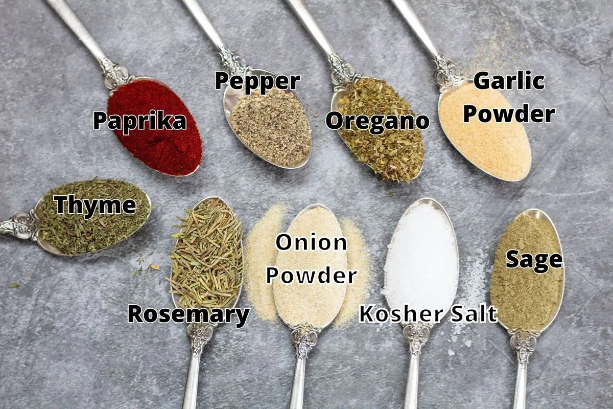 Prime rib rub ingredients in spoons with labels.