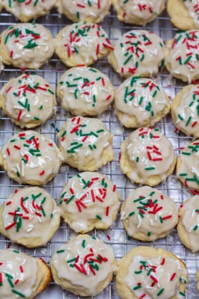 Process photo 10 iced and decorated Italian ricotta cookies on cooling rack.