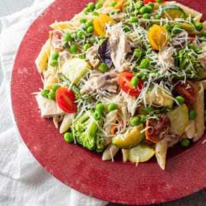 Leftover turkey pasta primavera garnished with fresh grated Parmesan cheese and purple basil.