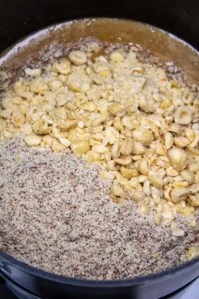 Process photo 9 add almond or hazelnut meal and crushed roasted hazelnuts.