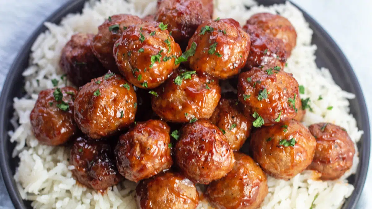 Wide overhead of the air fryer frozen meatballs served over rice.