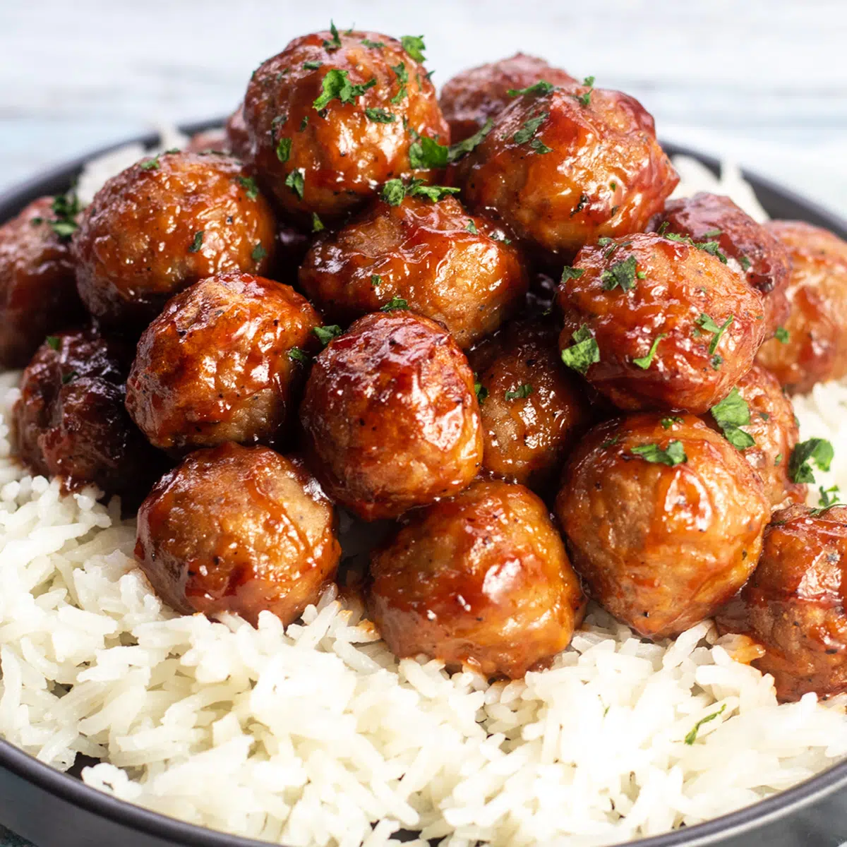 Albóndigas congeladas de la freidora mezcladas con salsa bbq y servidas con arroz.