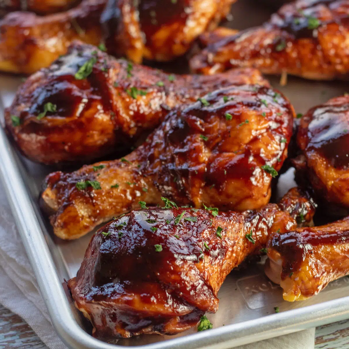 Baked bbq chicken drumsticks  garnished with some parsley and ready to serve.