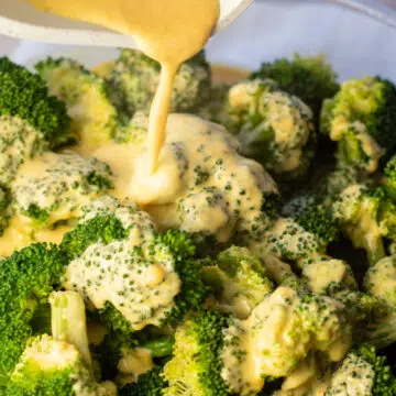 Wide image of the cheese sauce for broccoli being poured.