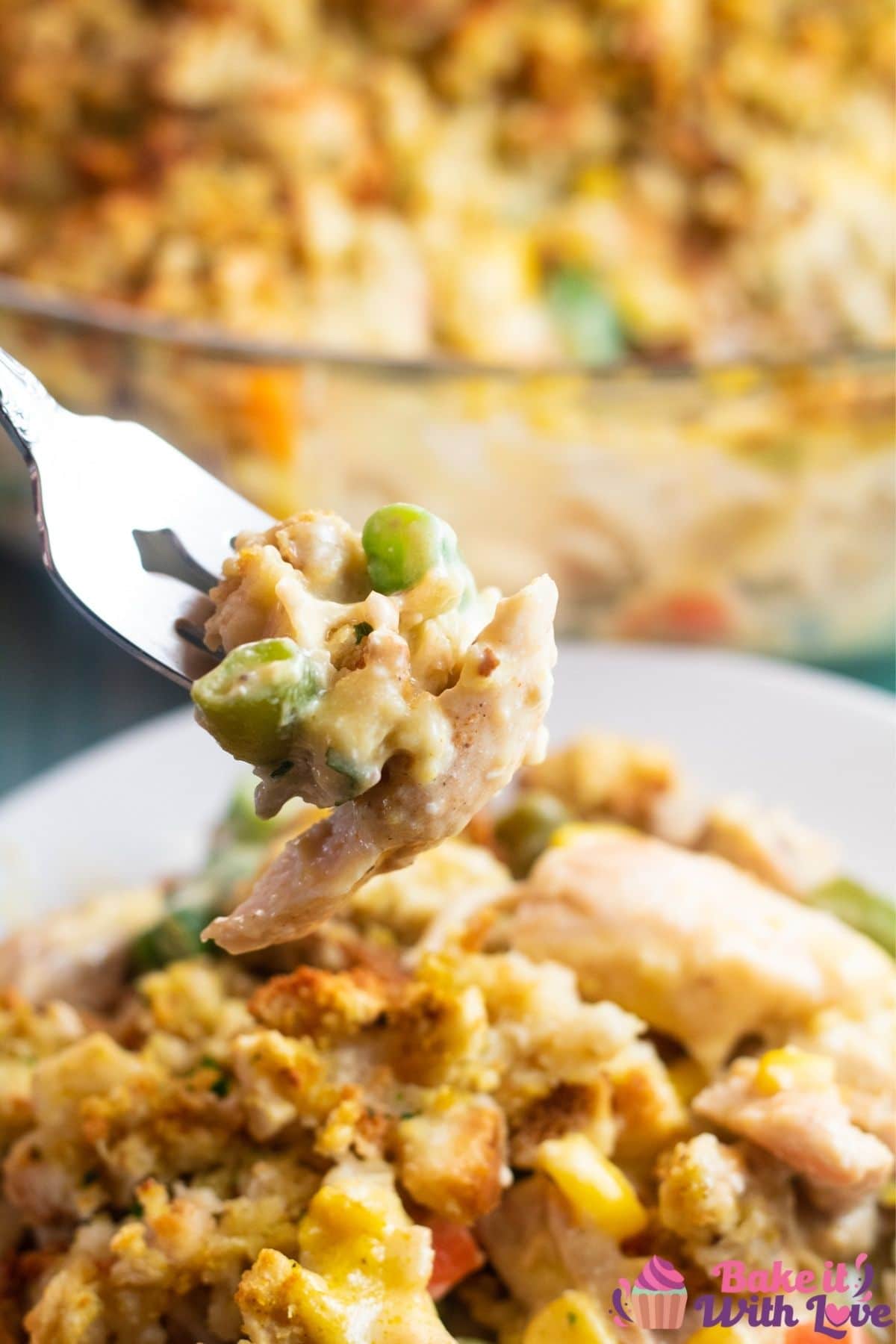 Chicken stuffing casserole on fork over plated casserole.