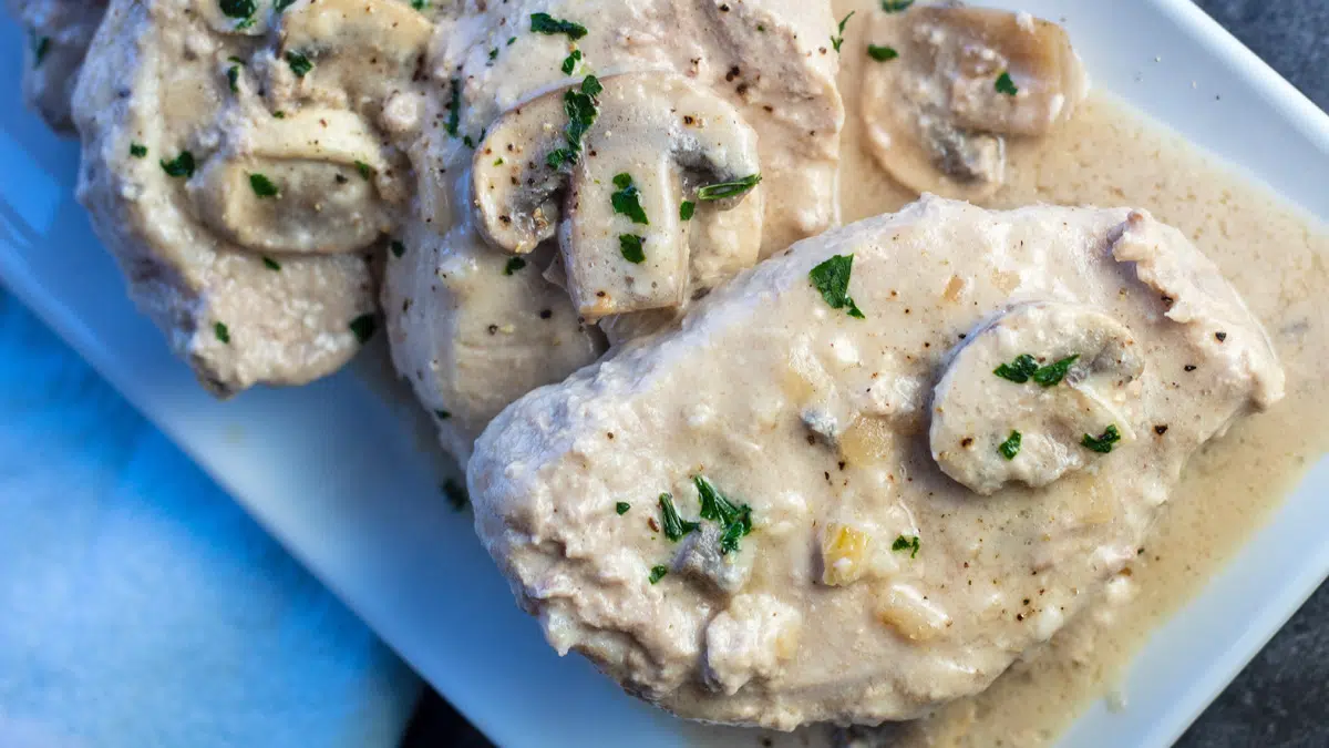 Wide overhead image of the plated crock pot pork chops.