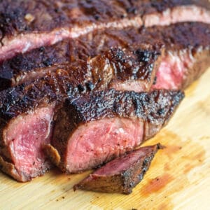 Closeup on the sliced pan seared flat iron steak on cutting board.