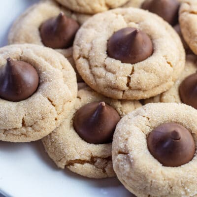 Peanut butter blossoms served on white plate.