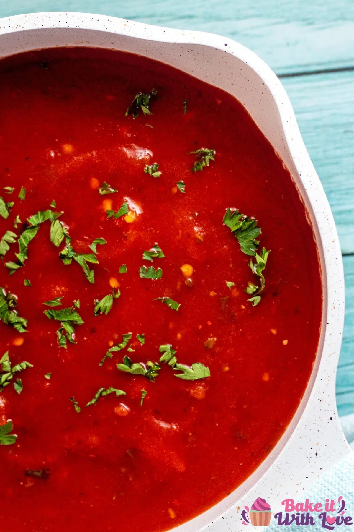 Overhead of the right half of saucepan with arrabbiata sauce.