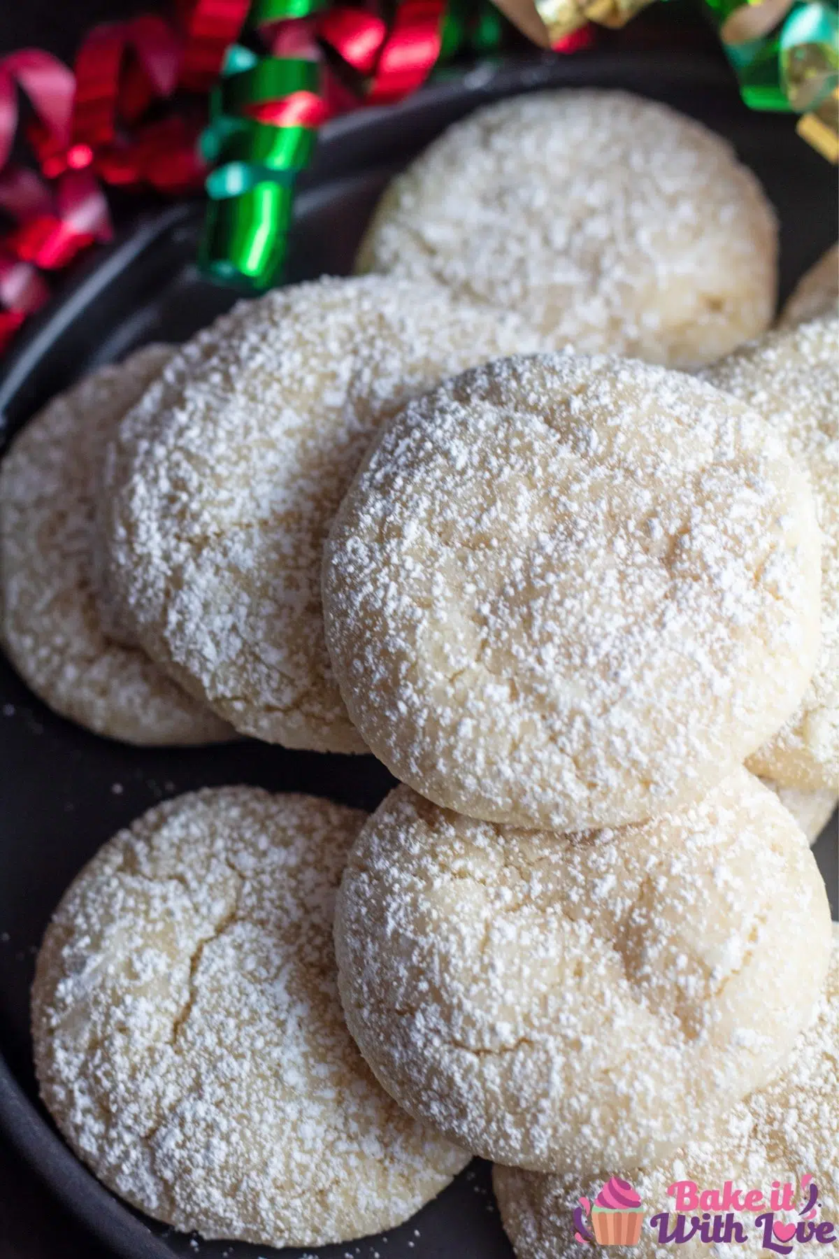 Tall overhead image of the vanilla crinkle cookies on black plate.