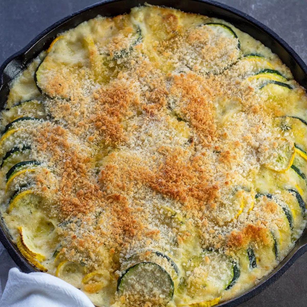 Overhead of the baked zucchini squash casserole in cast iron skillet.