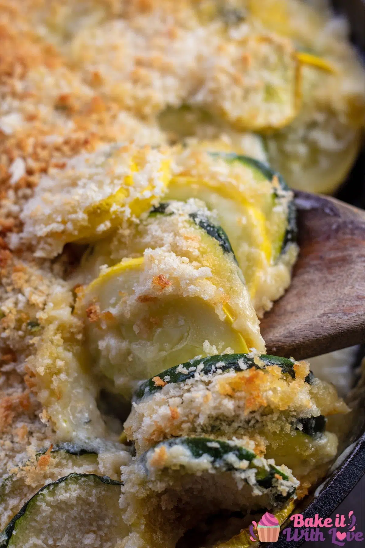 Tall closeup of the zucchini squash casserole being spooned out of skillet.