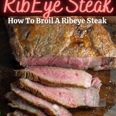 A pin image with text of broiled ribeye steak on a wood cutting board sliced.