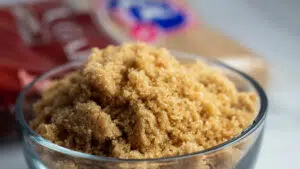 Wide image of brown sugar substitute image of brown sugar in bowl and packaged brown sugar in background.