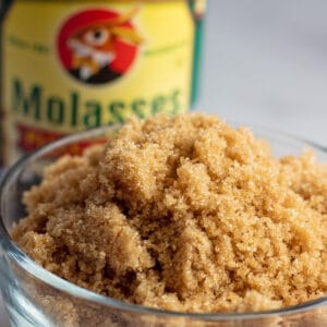Brown sugar substitute image wof brown sugar in bowl with molasses in background.