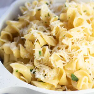 Closeup on the buttered noodles with parsley and Parmesan.